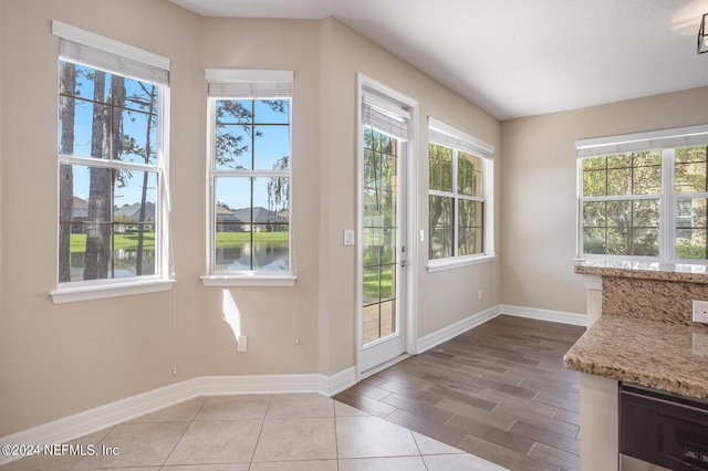 entryway with wood finished floors and baseboards