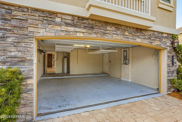 garage featuring a garage door opener, electric water heater, and electric panel