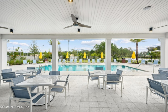 view of swimming pool with a patio area and ceiling fan