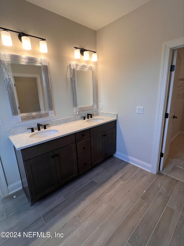 bathroom with hardwood / wood-style floors and vanity