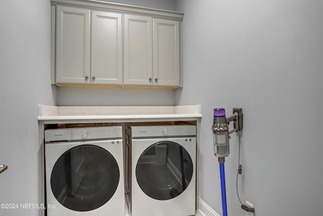 laundry area featuring cabinets and washing machine and clothes dryer