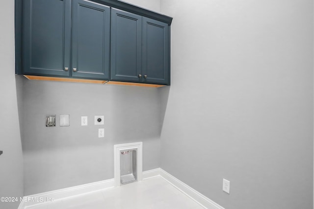 washroom featuring washer hookup, cabinet space, electric dryer hookup, baseboards, and tile patterned floors