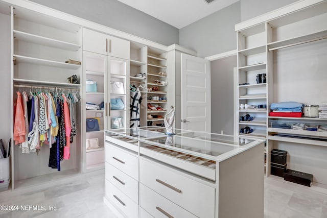 spacious closet with light tile patterned floors