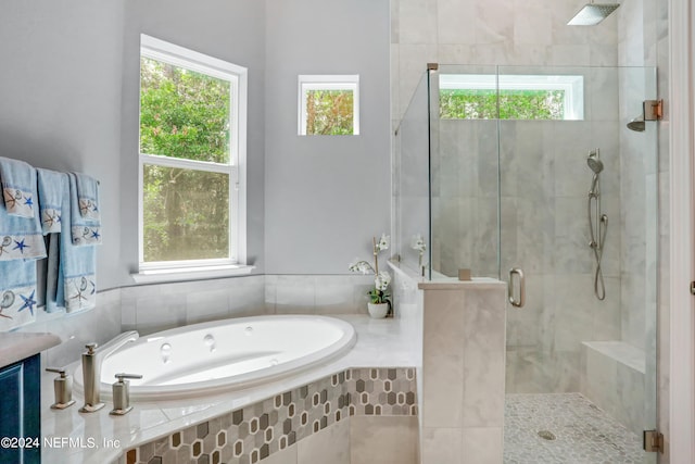 bathroom featuring separate shower and tub