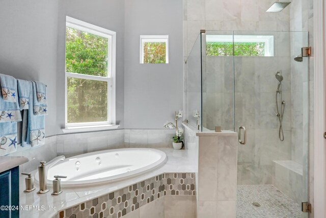 bathroom with a garden tub and a stall shower