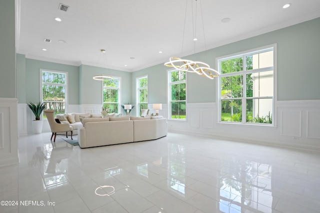 living room with ornamental molding and light tile patterned floors