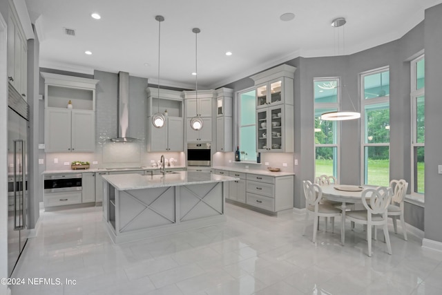 kitchen with ornamental molding, decorative light fixtures, stovetop, wall chimney range hood, and open shelves