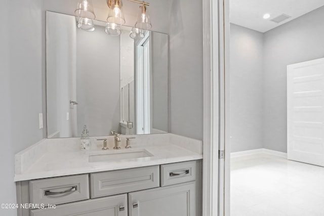 bathroom featuring vanity and a notable chandelier