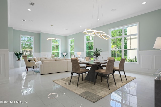 432 Aj Mills Rd, Ponte Vedra, FL 32081 - dining space featuring a decorative wall, plenty of natural light, wainscoting, crown molding, and a chandelier
