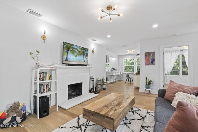 living room with a chandelier and light hardwood / wood-style floors