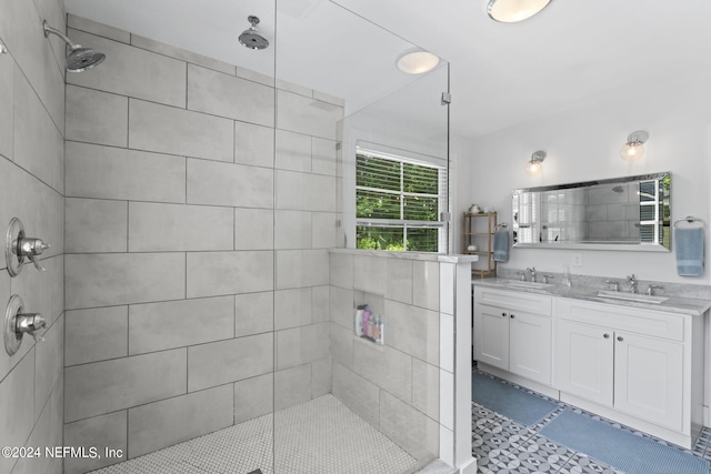 bathroom featuring tiled shower and vanity