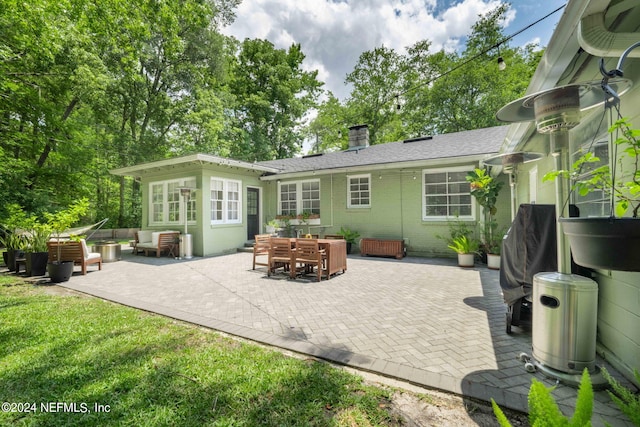 rear view of house featuring a patio and an outdoor hangout area