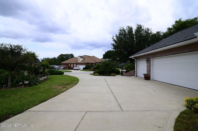 exterior space featuring a garage and a lawn