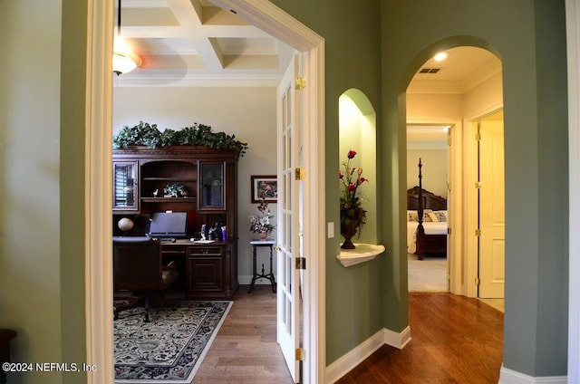 corridor featuring hardwood / wood-style floors, crown molding, coffered ceiling, and beamed ceiling