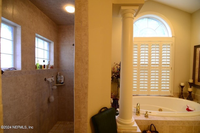 bathroom with shower with separate bathtub and decorative columns