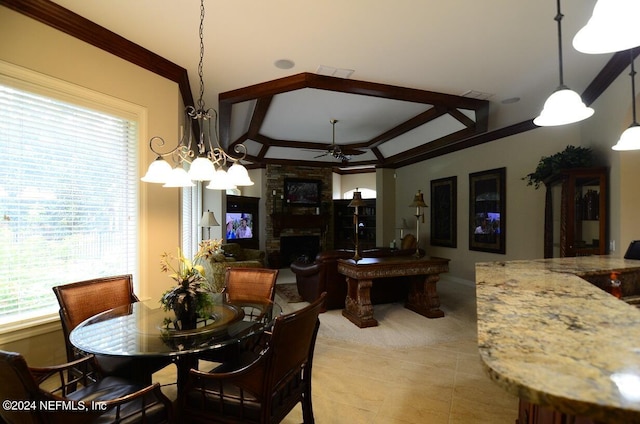 tiled dining room with a fireplace, ceiling fan with notable chandelier, and ornamental molding