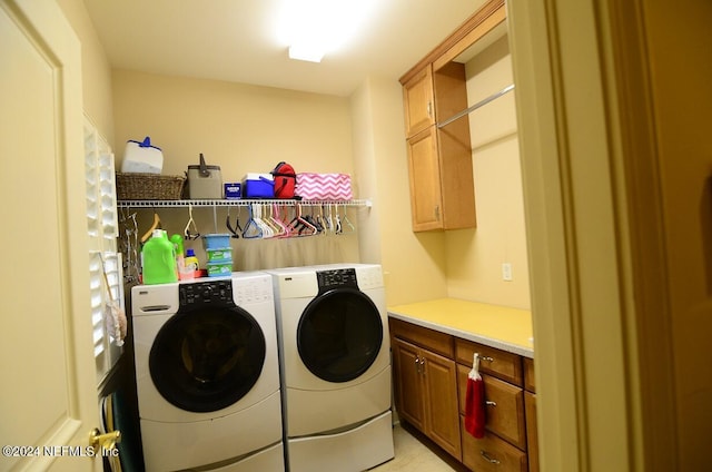 laundry room featuring cabinets and washer and dryer