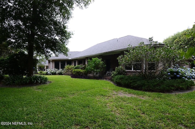 rear view of house with a yard