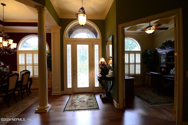 foyer entrance with a healthy amount of sunlight, crown molding, and decorative columns