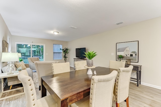 dining space with light wood-type flooring