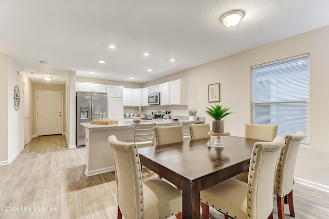 dining area with light wood-type flooring