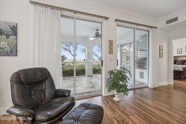 sitting room featuring ceiling fan, plenty of natural light, ornamental molding, and hardwood / wood-style flooring