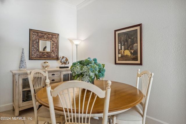 tiled dining area featuring ornamental molding