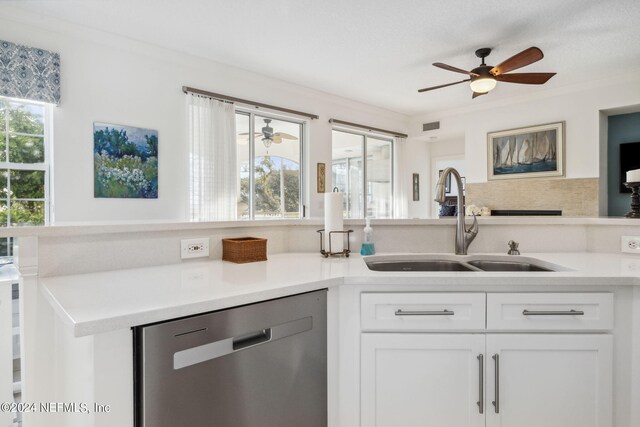 kitchen with sink, tasteful backsplash, stainless steel dishwasher, crown molding, and white cabinets