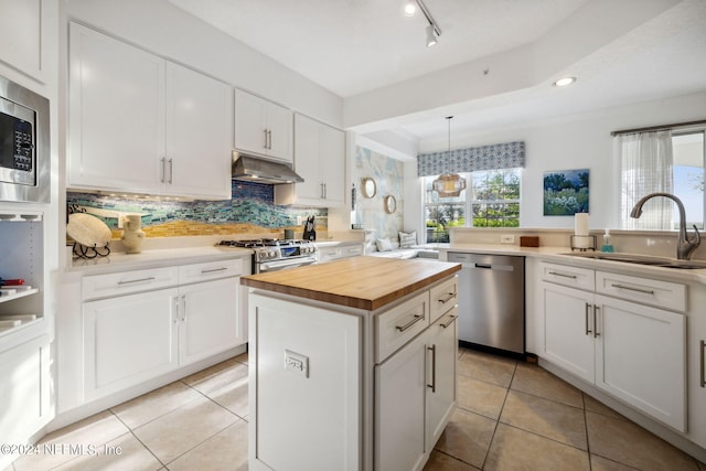 kitchen featuring a center island, sink, white cabinetry, and stainless steel appliances