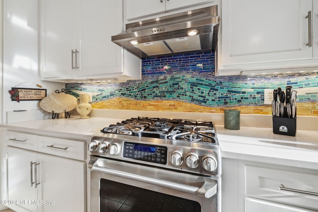 kitchen featuring white cabinets, decorative backsplash, high end range, and extractor fan