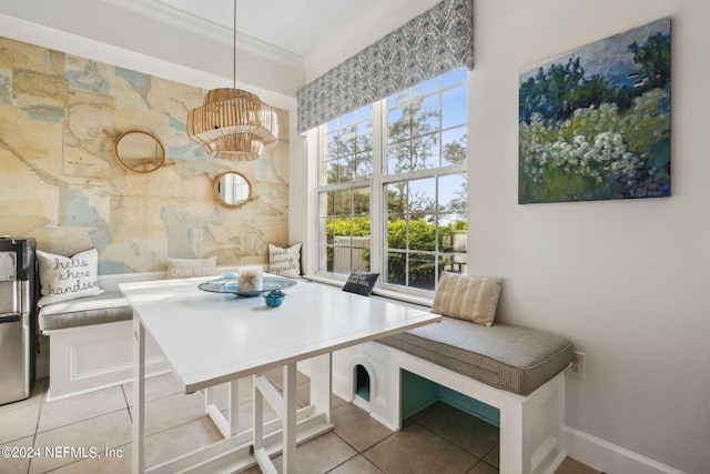 dining space featuring tile patterned floors and crown molding