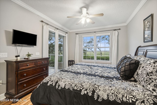 bedroom featuring access to exterior, ceiling fan, a textured ceiling, and ornamental molding