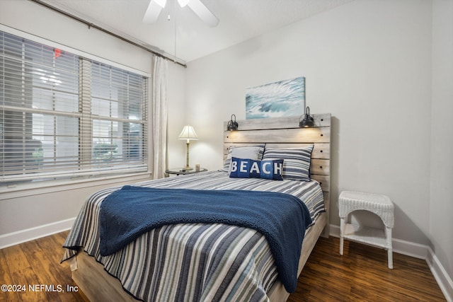 bedroom featuring ceiling fan and dark wood-type flooring