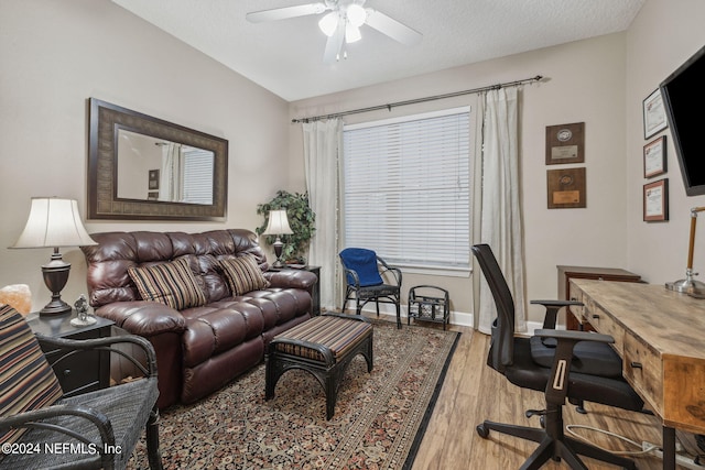 office space featuring ceiling fan, a textured ceiling, and light wood-type flooring