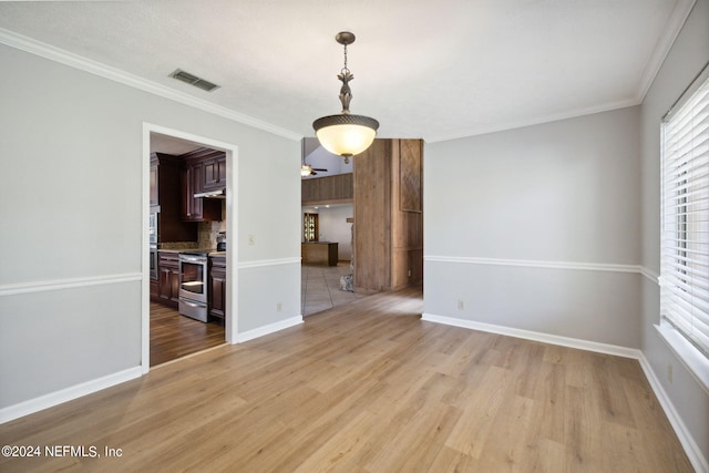 interior space featuring ornamental molding and light wood-type flooring