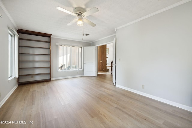 interior space featuring a textured ceiling, ornamental molding, ceiling fan, and light wood-type flooring