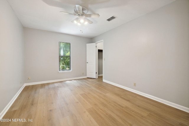 spare room featuring light hardwood / wood-style flooring and ceiling fan