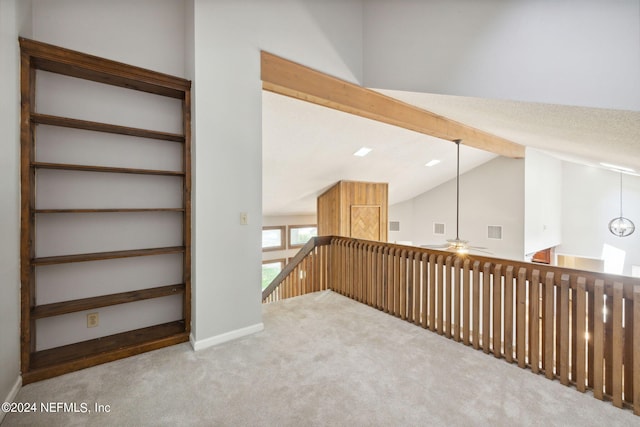 hall with lofted ceiling with beams and carpet flooring