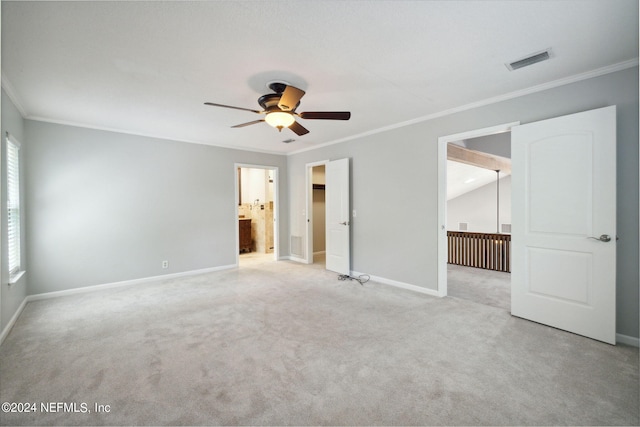 carpeted spare room featuring ceiling fan and ornamental molding