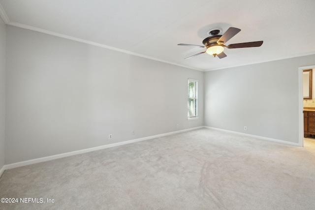 carpeted spare room with crown molding and ceiling fan