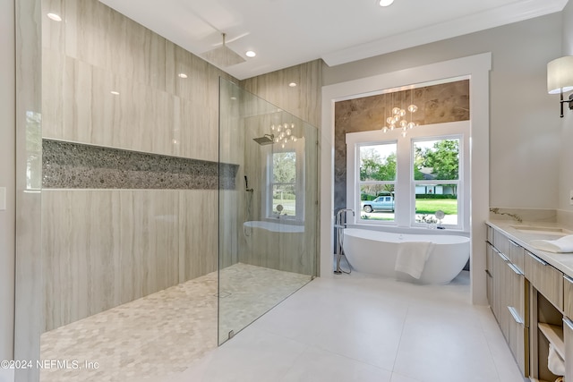 bathroom featuring ornamental molding, independent shower and bath, tile floors, a notable chandelier, and vanity