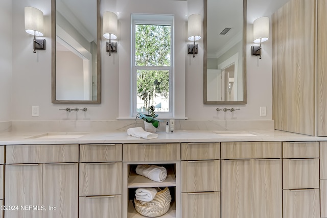 bathroom featuring dual bowl vanity and ornamental molding