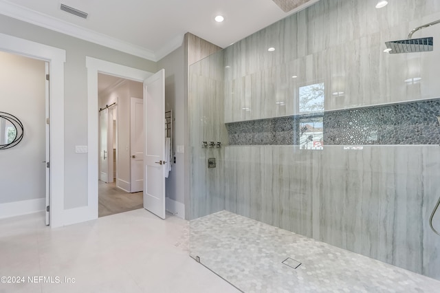 bathroom with tiled shower, tile flooring, and ornamental molding