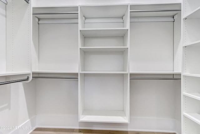 walk in closet with wood-type flooring