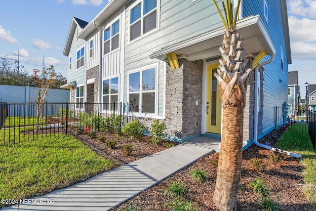 entrance to property featuring a yard