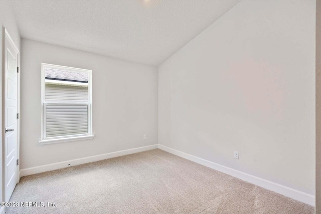 carpeted empty room with a textured ceiling