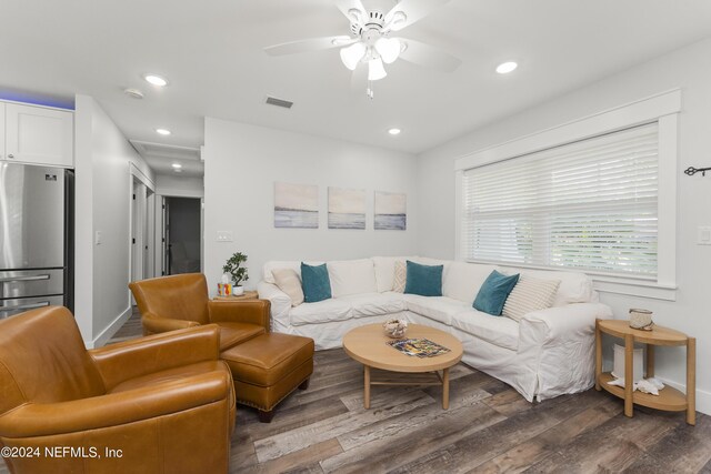 living room featuring dark hardwood / wood-style floors and ceiling fan