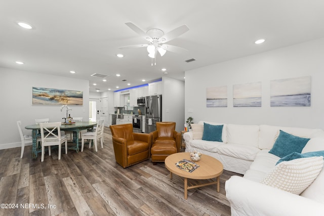 living room with ceiling fan, sink, and hardwood / wood-style flooring