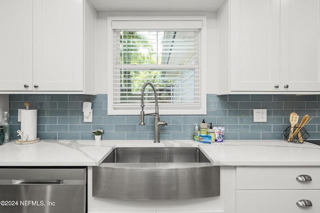 kitchen featuring white cabinets, backsplash, stainless steel dishwasher, and sink