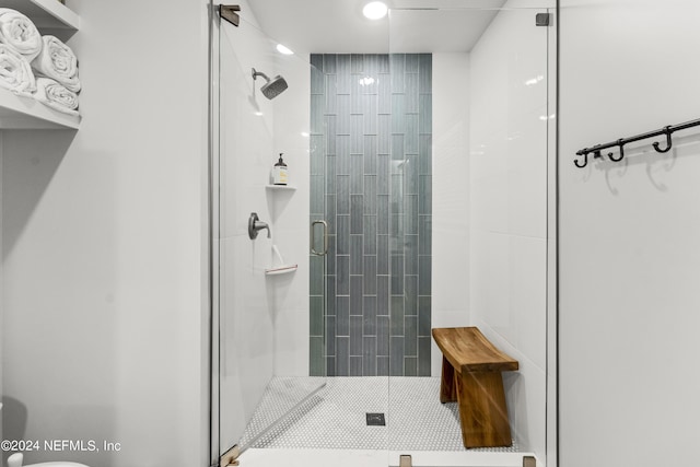 bathroom featuring tile patterned flooring and a shower with shower door